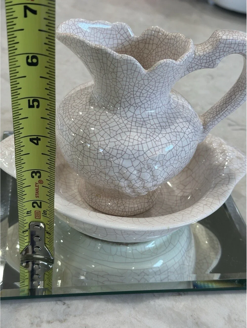 Farmhouse-style pitcher and basin set, featuring a distinct white crackle finish